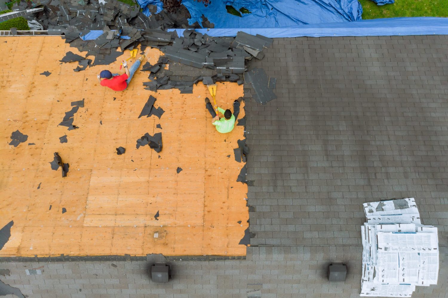 Removal of old roof replacement with new shingles of an apartment building